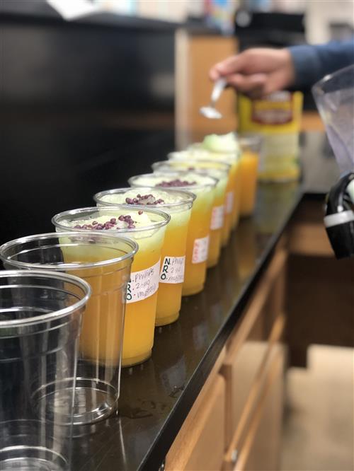 a line of gibbs bucks coffee being filled by student worker 